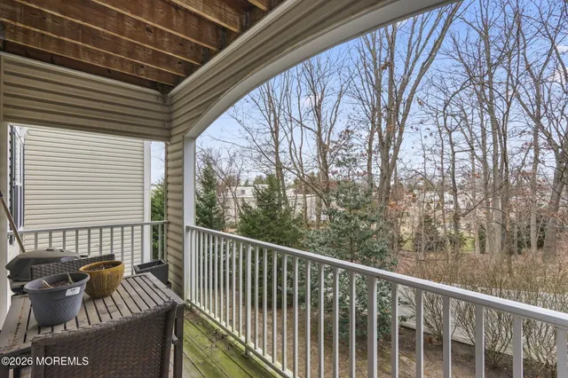 a balcony with wooden floor and outdoor space