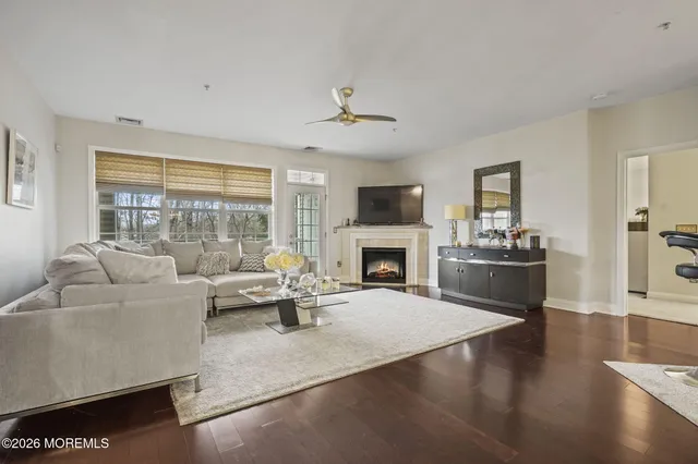 a living room with furniture fireplace and a large window