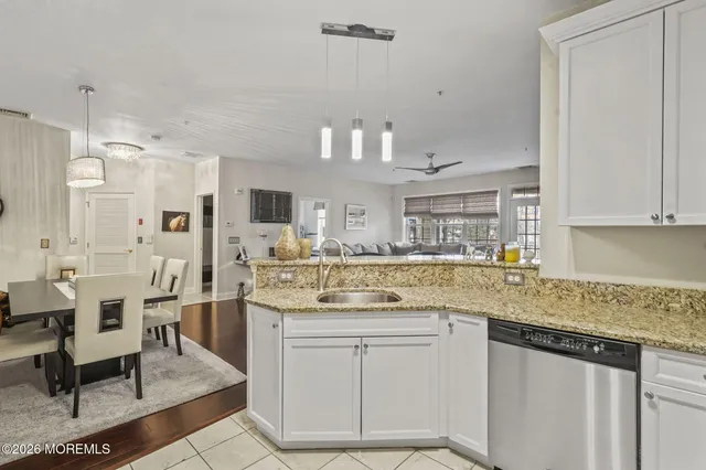 a kitchen with stainless steel appliances granite countertop a sink and cabinets