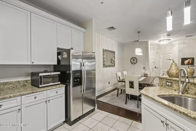 a kitchen with stainless steel appliances granite countertop a sink and cabinets