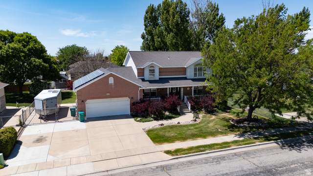 5727 South 3550th Street West Roy, UT 84067 - Photo 37 of 49 Brick and siding exterior with a covered front porch featuring white railings