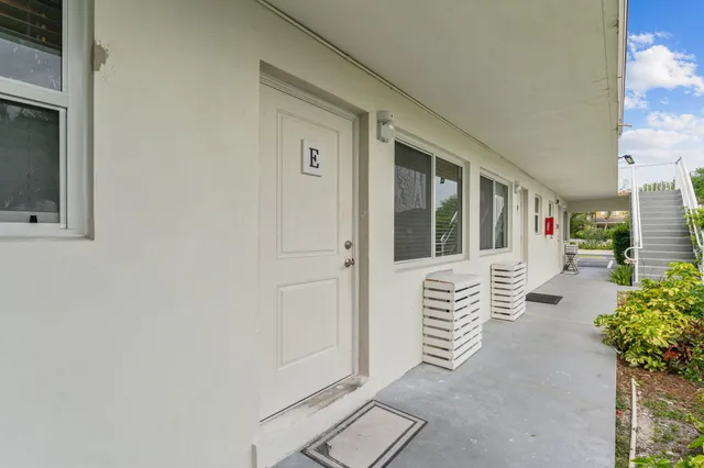 a view of an entryway with wooden floor and garden