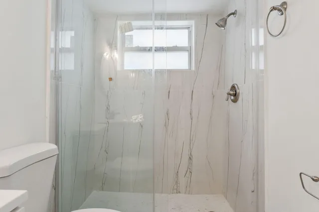 a bathroom with a glass shower door