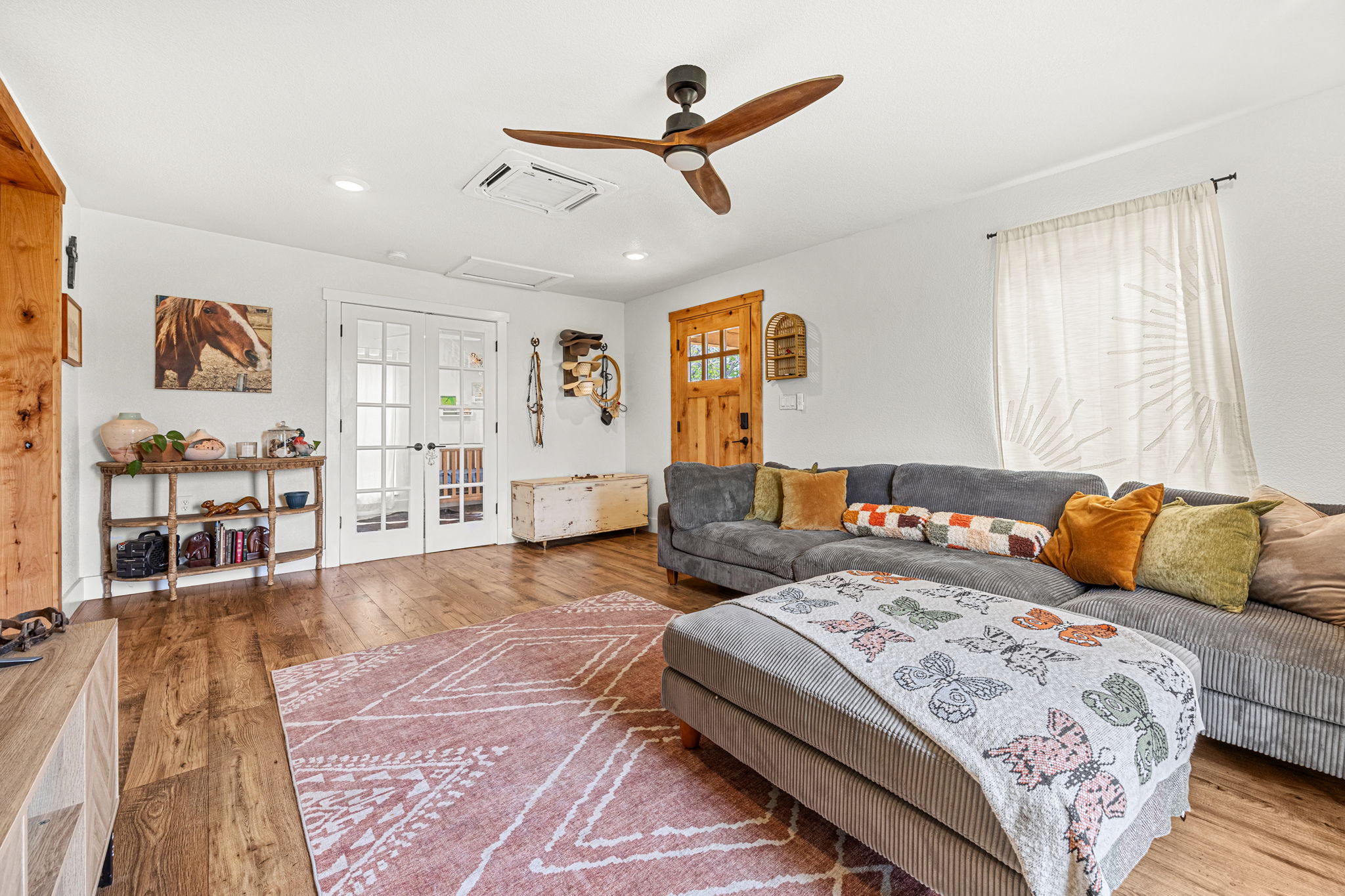 13390 Bendle Road Troy, TX 76579 - Photo 11 of 30 a spacious bedroom with a large bed and a wooden floor