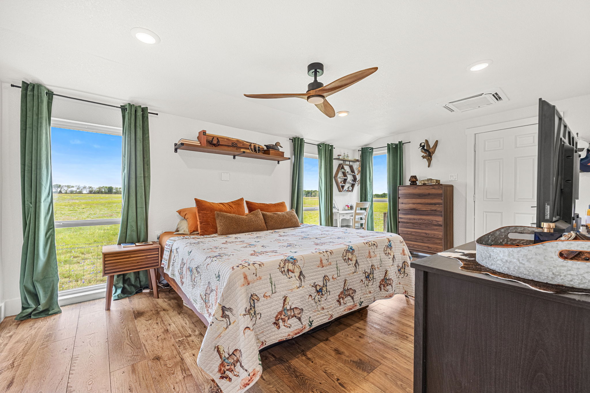 13390 Bendle Road Troy, TX 76579 - Photo 4 of 30 a bedroom with a bed and a dresser with wooden floor