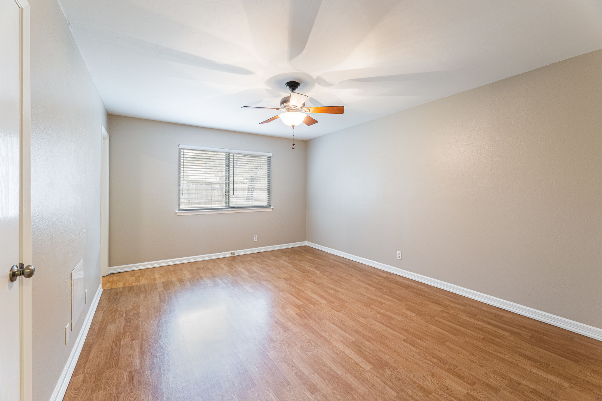 12914 Pegasus Street Austin, TX 78727 - Photo 14 of 30 Unfurnished room featuring light wood-style flooring and a ceiling fan