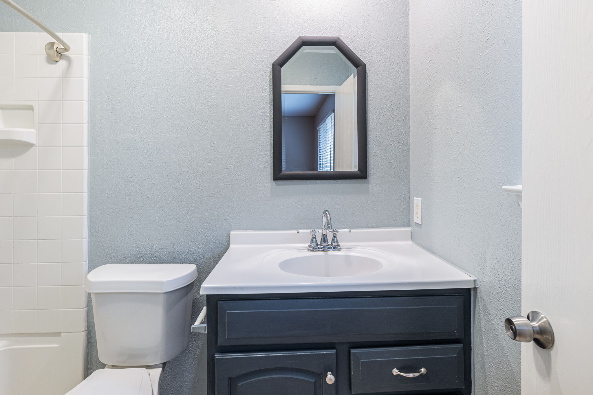 12914 Pegasus Street Austin, TX 78727 - Photo 18 of 30 Full bathroom with vanity, tub / shower combination, and a textured wall