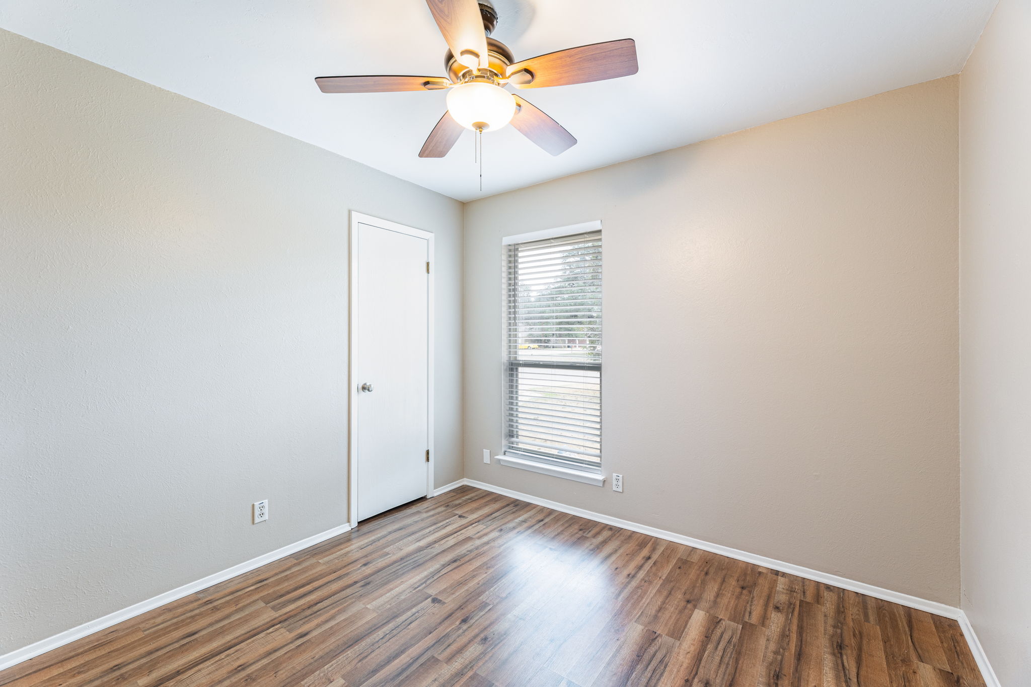 12914 Pegasus Street Austin, TX 78727 - Photo 21 of 30 Empty room with wood finished floors and ceiling fan