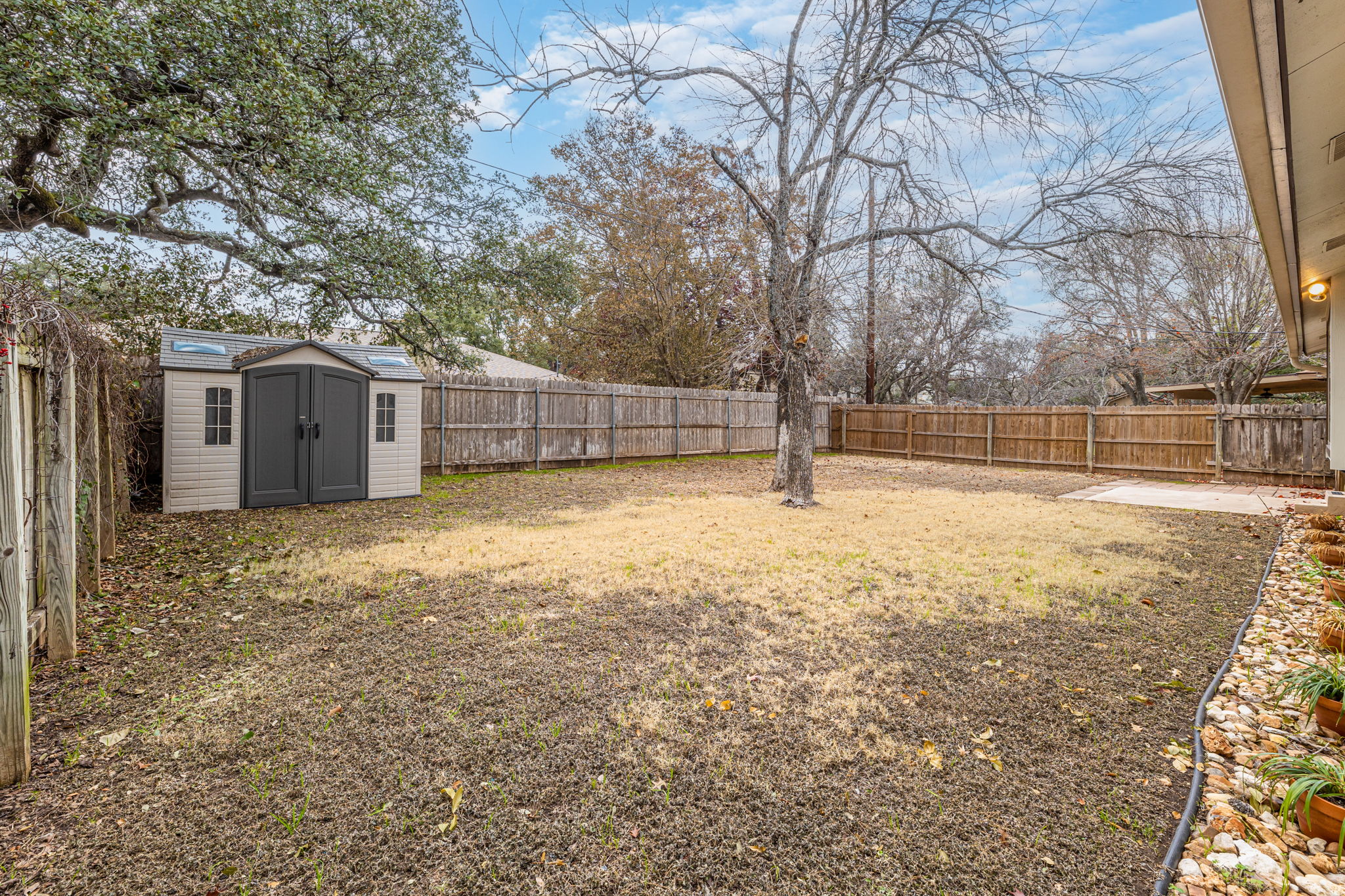 12914 Pegasus Street Austin, TX 78727 - Photo 28 of 30 Fenced backyard with a storage unit