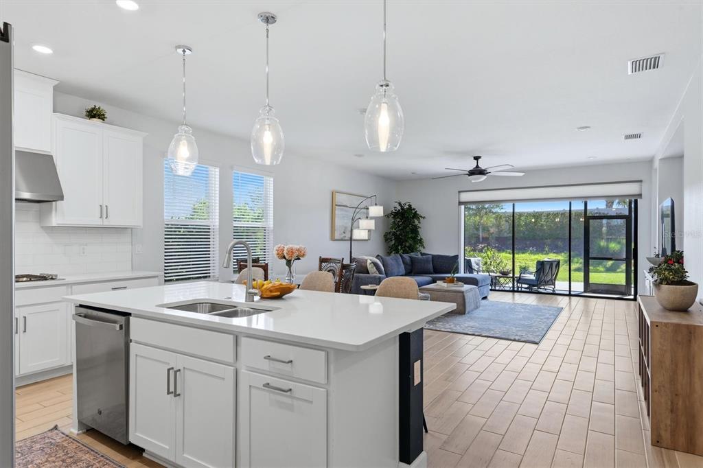 9268 Tequila Sunrise Drive Sarasota, FL 34241 - Photo 18 of 56 a kitchen with a sink stove and wooden floor