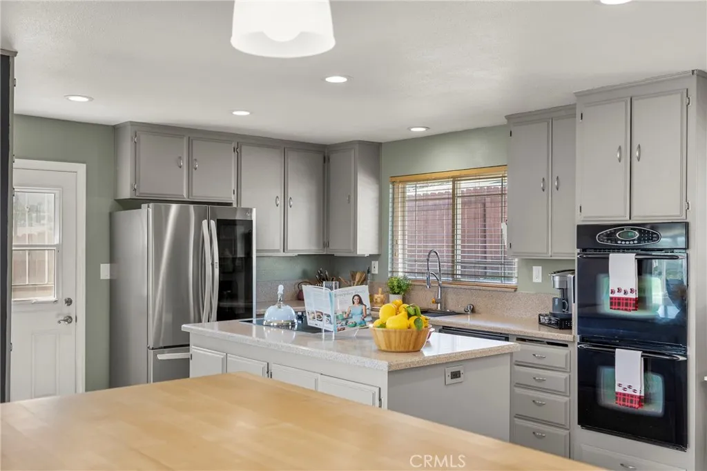 8861 Los Coches Road, Unit 1 Lakeside, CA 92040 - Photo 14 of 45 a kitchen with stainless steel appliances granite countertop a refrigerator sink and stove
