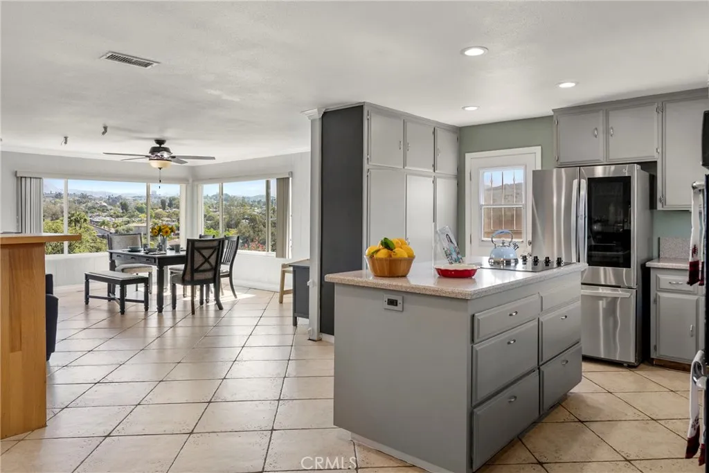 8861 Los Coches Road, Unit 1 Lakeside, CA 92040 - Photo 17 of 45 a kitchen with a dining table chairs and refrigerator