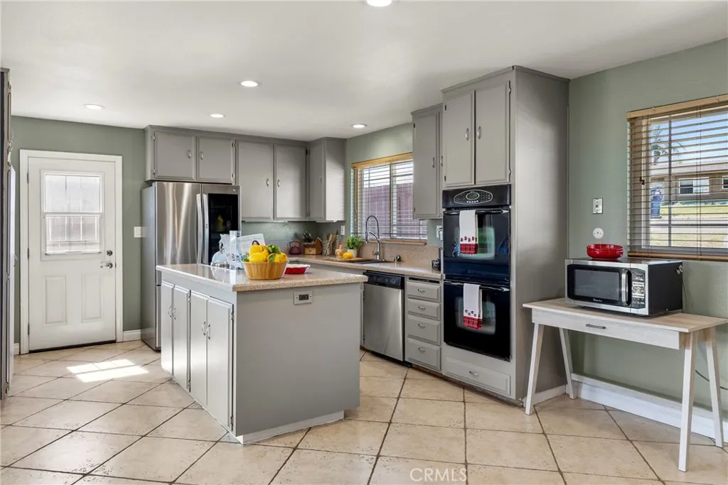 8861 Los Coches Road, Unit 1 Lakeside, CA 92040 - Photo 20 of 45 a kitchen with stainless steel appliances kitchen island granite countertop a refrigerator and a stove