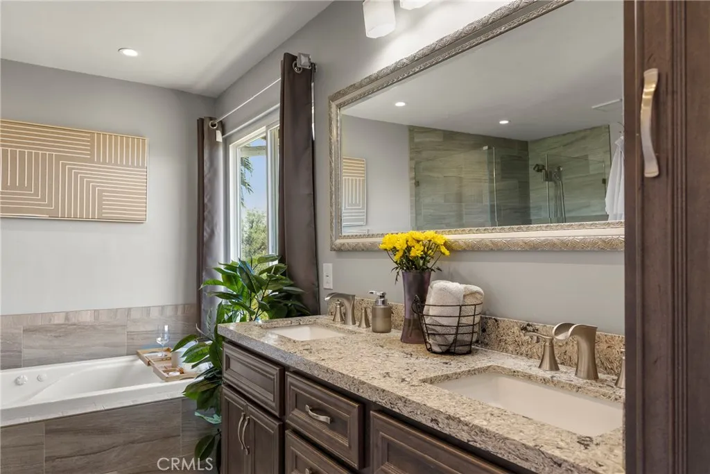 8861 Los Coches Road, Unit 1 Lakeside, CA 92040 - Photo 23 of 45 a bathroom with a granite countertop sink and a bathtub