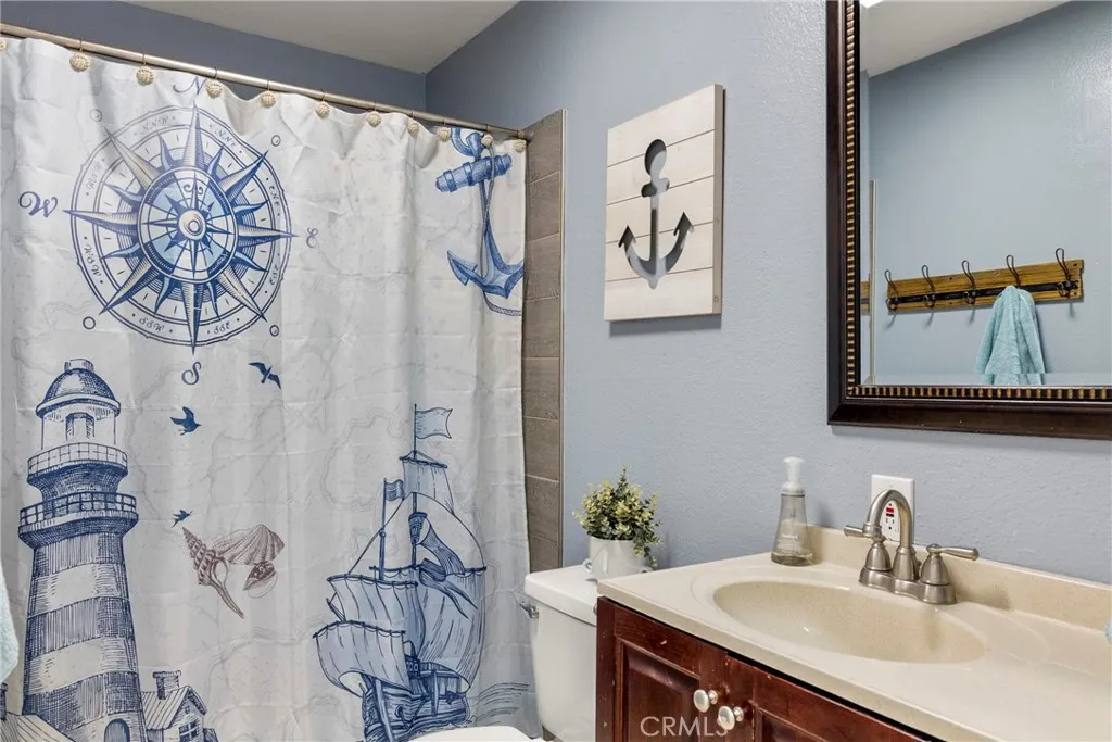 8861 Los Coches Road, Unit 1 Lakeside, CA 92040 - Photo 26 of 45 a bathroom with a sink and a mirror