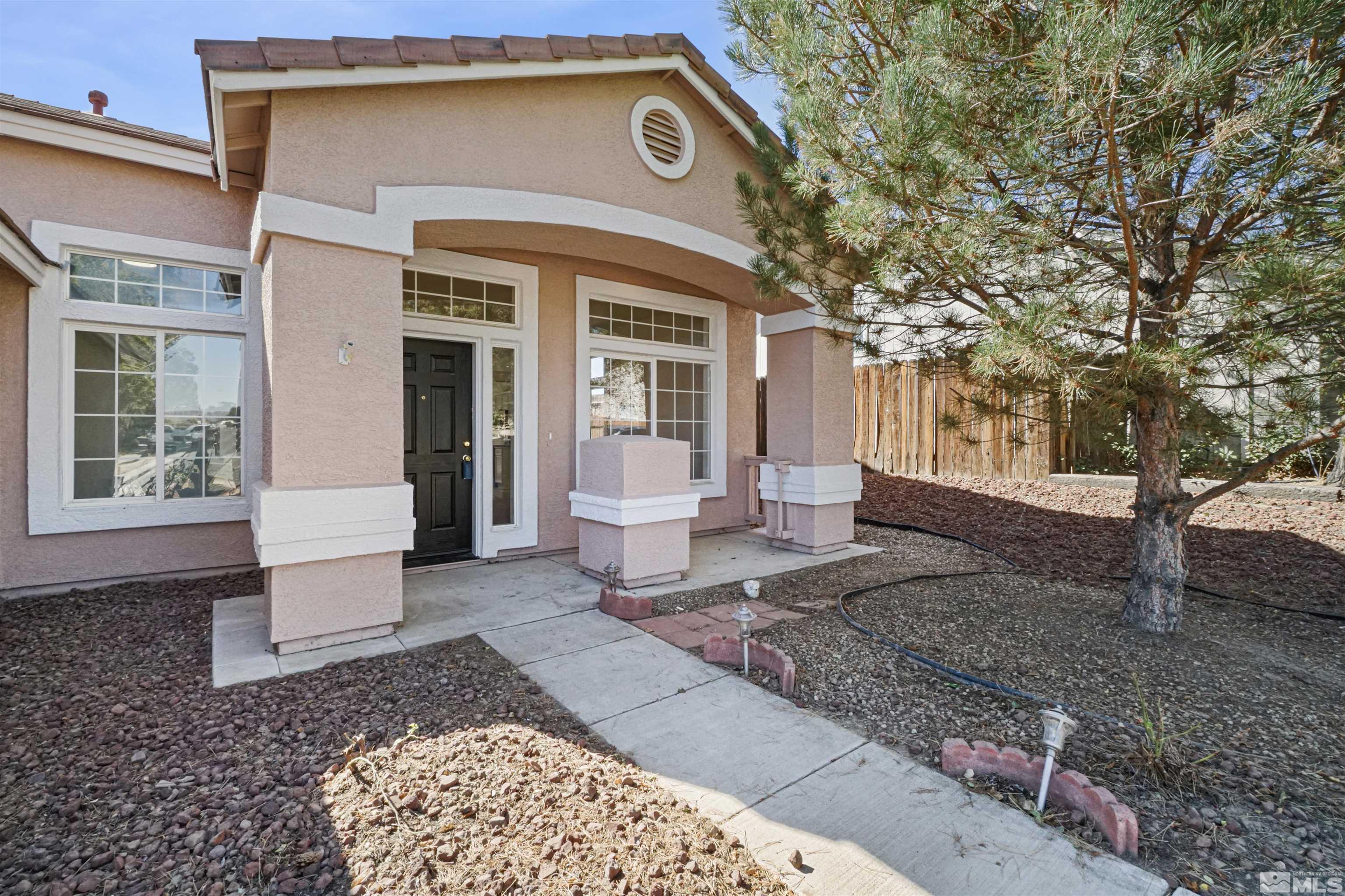 1043 Brierwood Lane Fernley, NV 89408 - Photo 2 of 27 a front view of a house with a yard