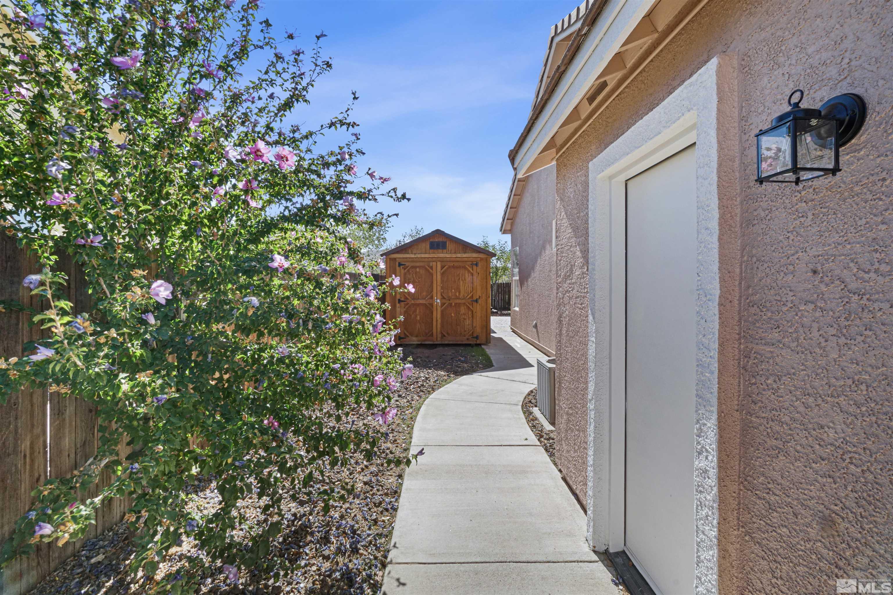 1043 Brierwood Lane Fernley, NV 89408 - Photo 27 of 27 a front view of a house with a yard