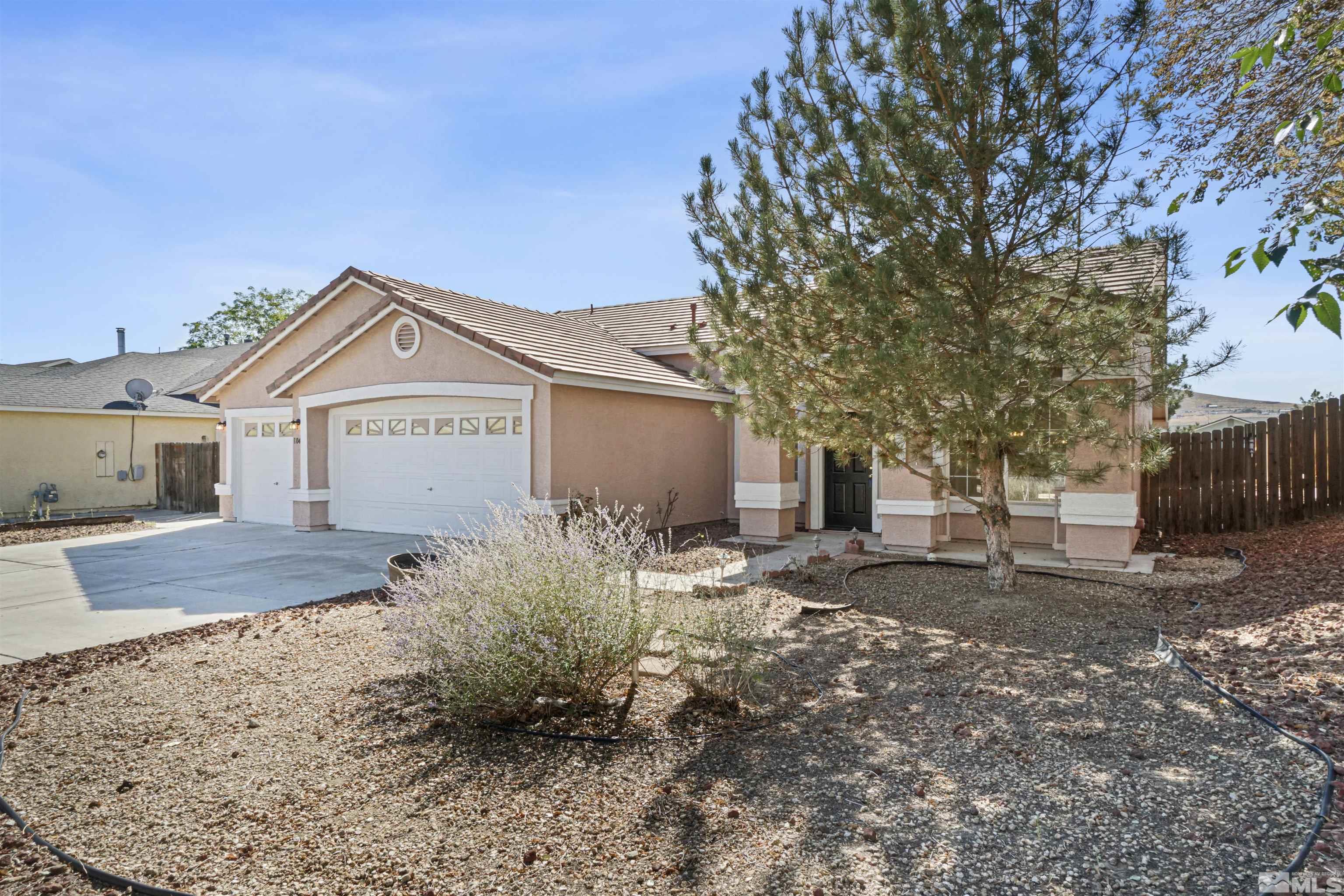 1043 Brierwood Lane Fernley, NV 89408 - Photo 3 of 27 a front view of a house with garden