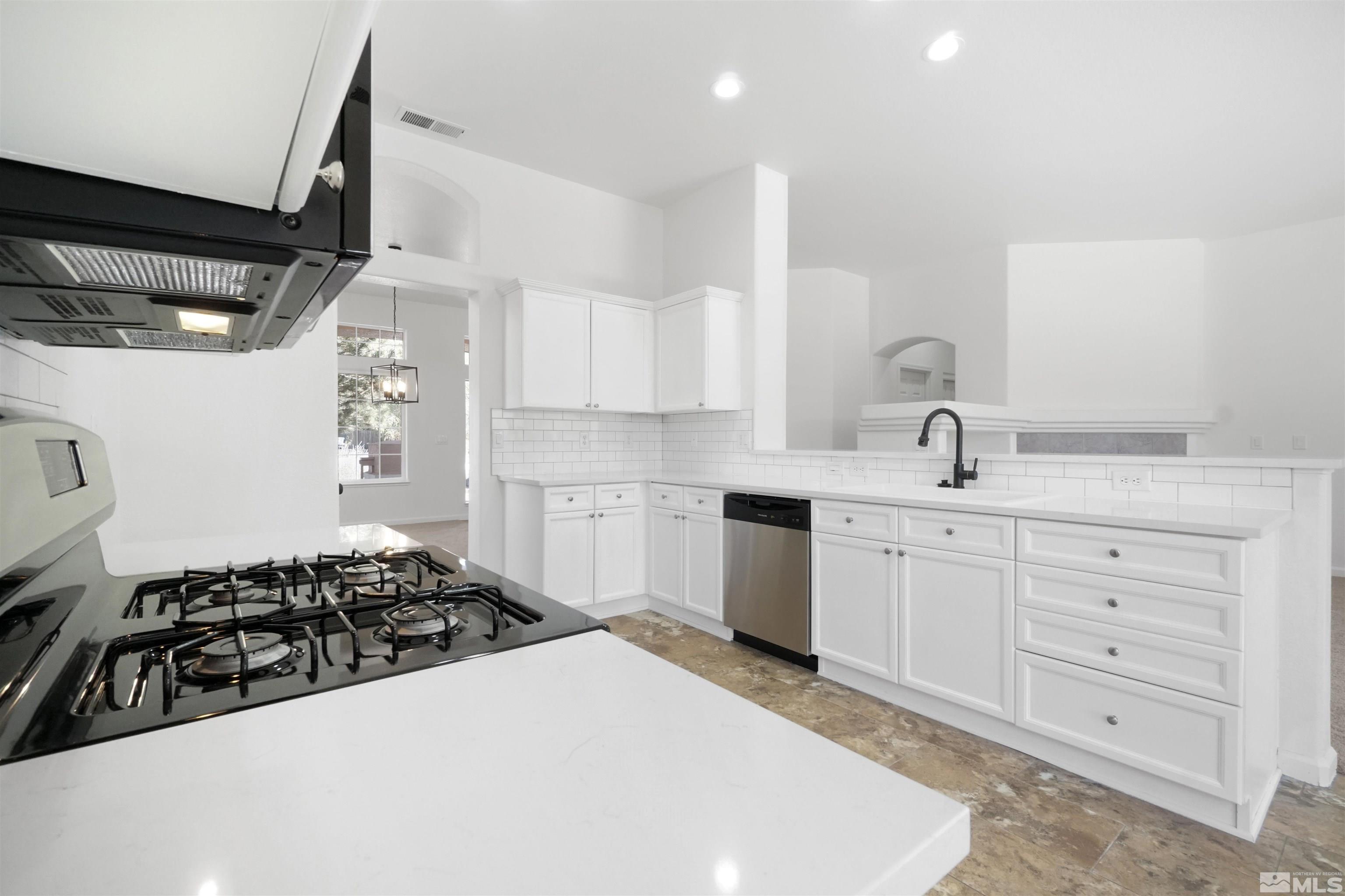 1043 Brierwood Lane Fernley, NV 89408 - Photo 6 of 27 a kitchen with a sink a stove and cabinets