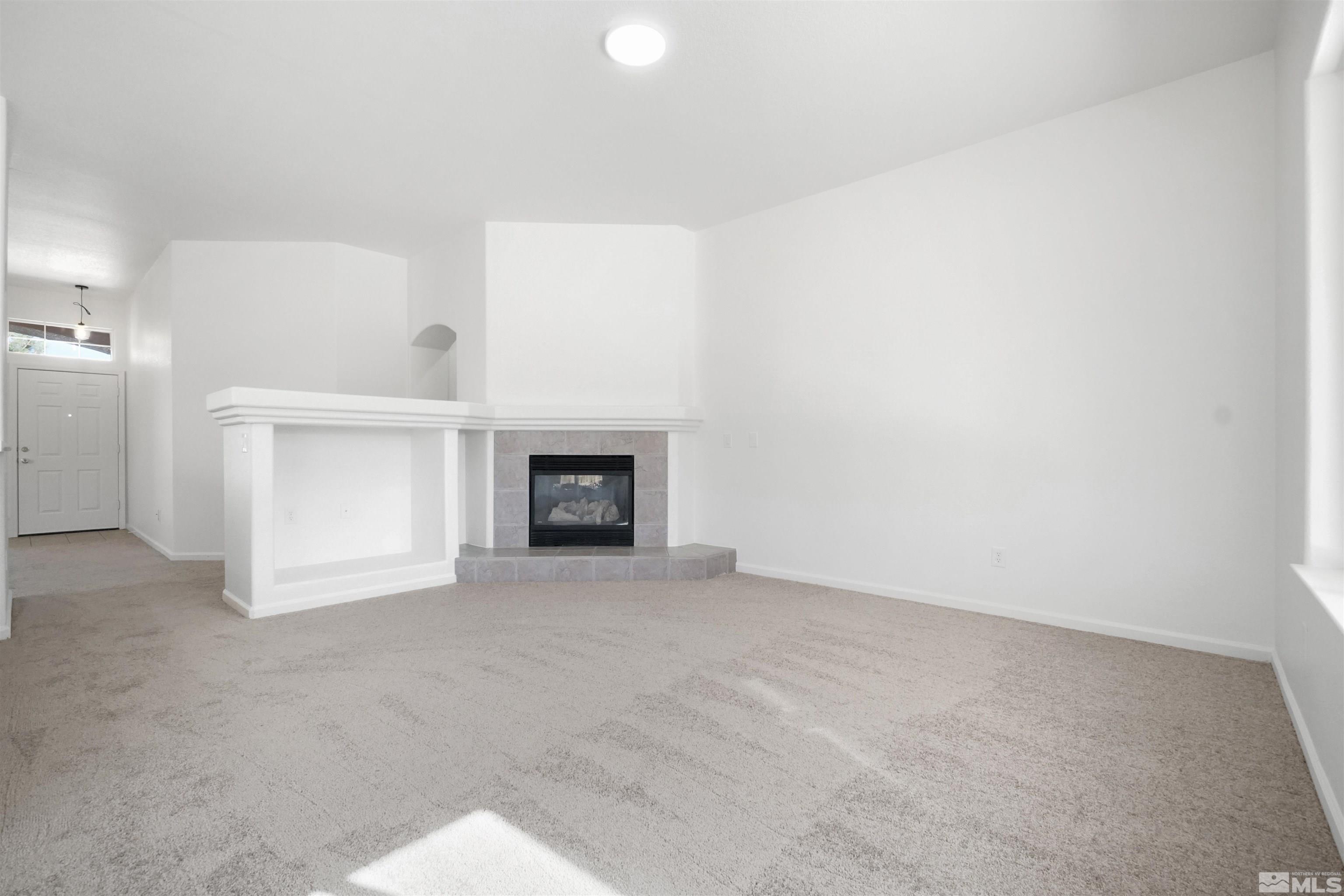 1043 Brierwood Lane Fernley, NV 89408 - Photo 8 of 27 a view of an empty room with a fireplace