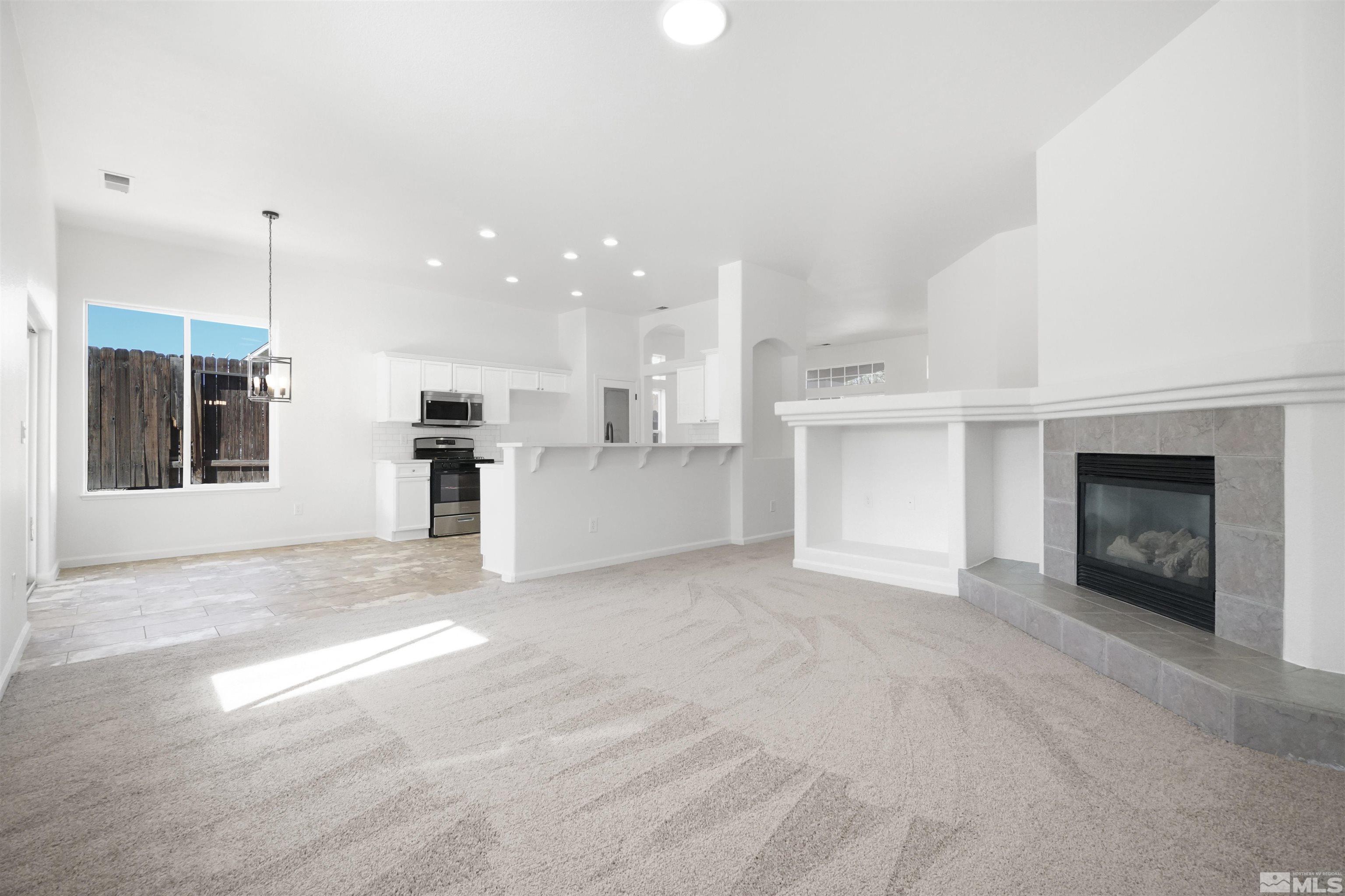 1043 Brierwood Lane Fernley, NV 89408 - Photo 9 of 27 a view of a kitchen with kitchen island a sink stainless steel appliances and cabinets