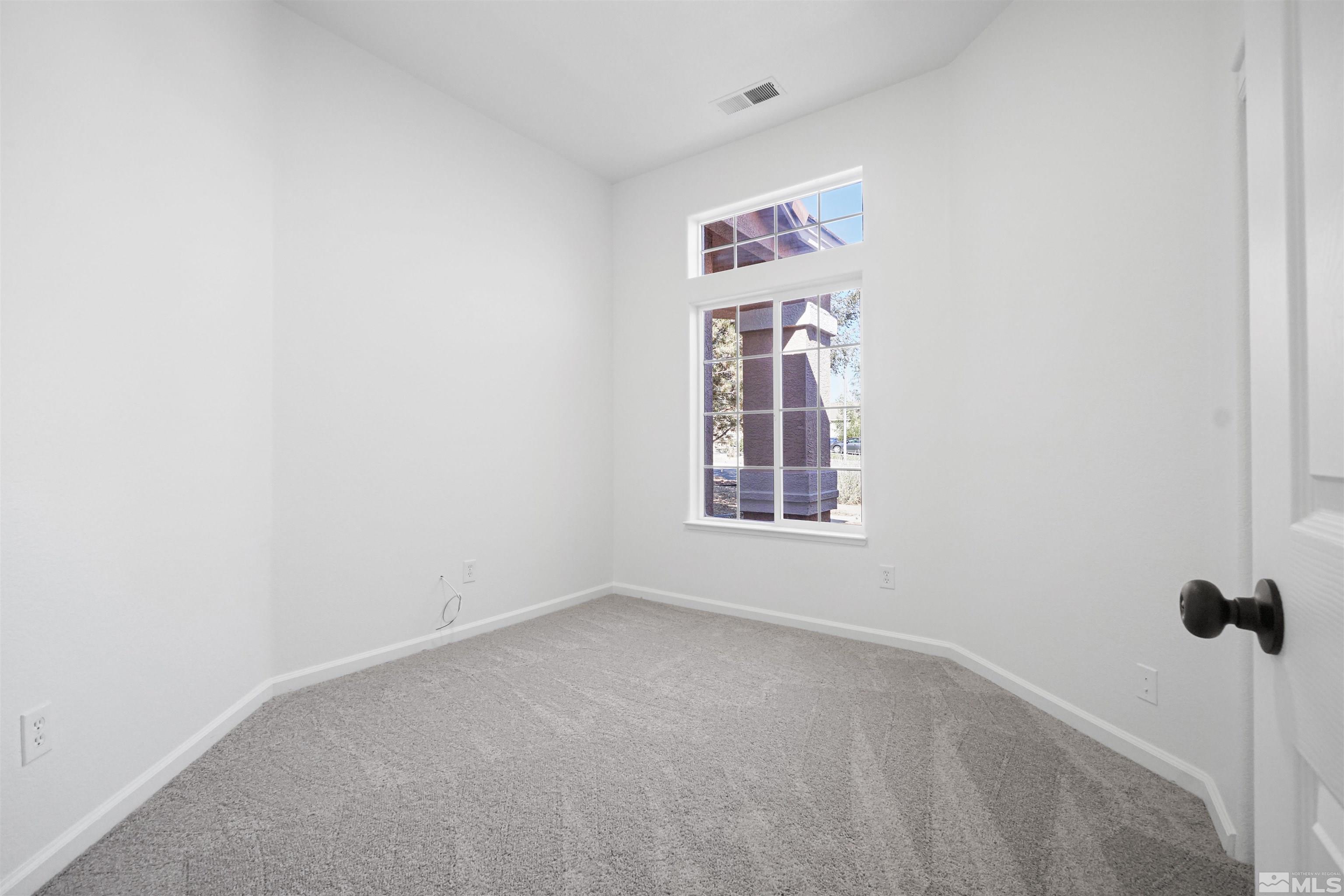 1043 Brierwood Lane Fernley, NV 89408 - Photo 10 of 27 a view of an empty room with a window