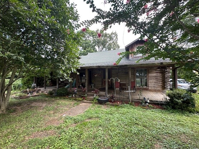 a view of a chair and table in backyard of the house