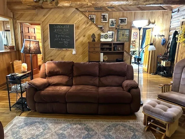 a view of living room with furniture and a fireplace