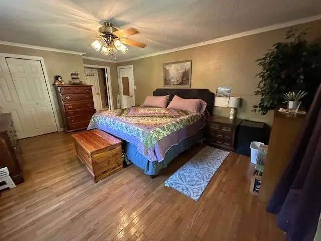 a bedroom with a bed window and a dresser