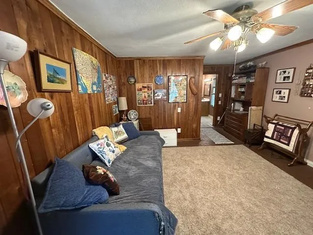 a living room with furniture a chandelier and a flat screen tv