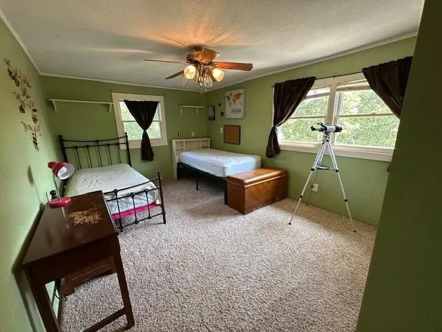 a room with furniture pool table and window