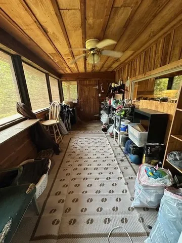 a bedroom with furniture and a large window
