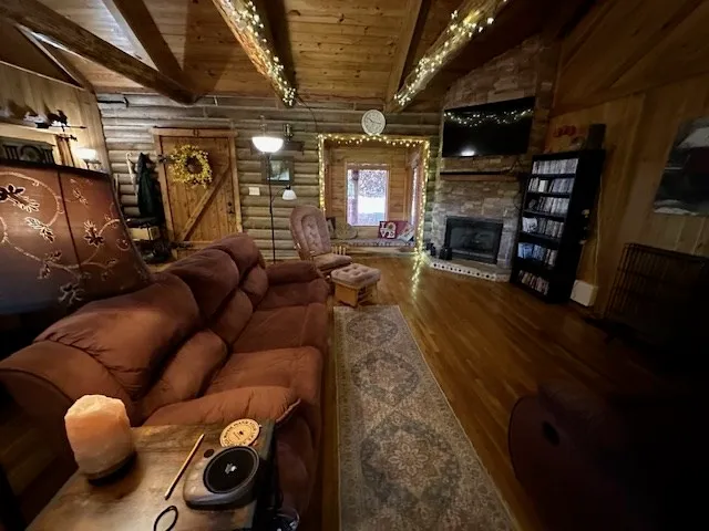 a living room with furniture a flat screen tv and a fireplace