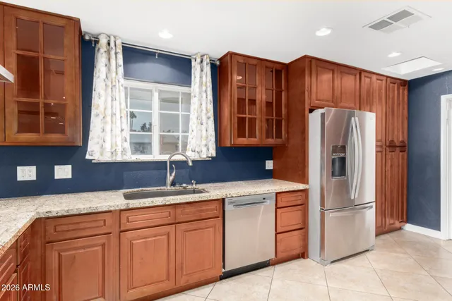a kitchen with stainless steel appliances granite countertop a sink and cabinets