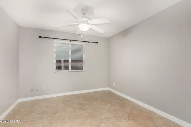 an empty room with closet and a hallway