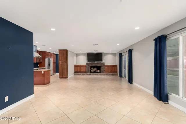 a living room with a fireplace and a flat screen tv