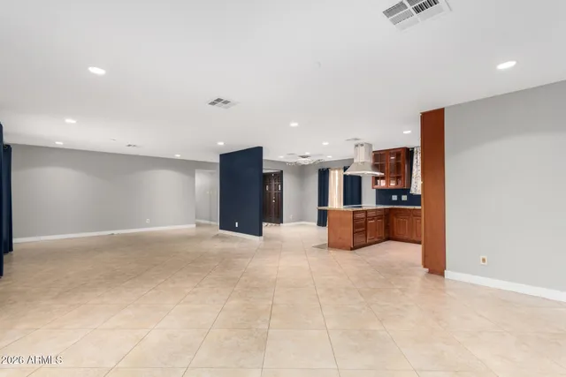 a large kitchen with stainless steel appliances granite countertop a refrigerator and a sink