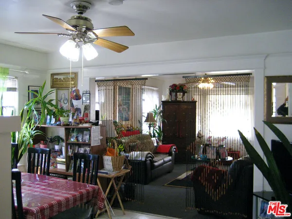 a living room with furniture a flat screen tv and a large window