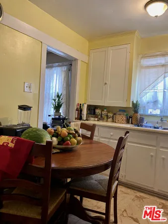 a table with a clock on it and wooden floor