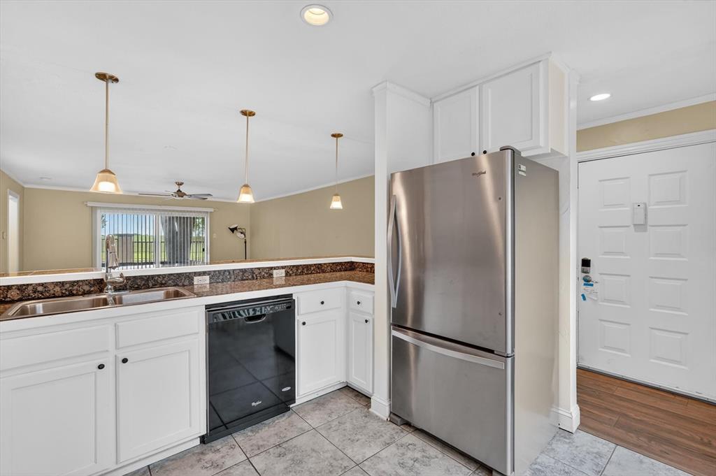 4549 North O'Connor Road, Unit 1262 Irving, TX 75062 - Photo 8 of 21 a kitchen with a refrigerator a sink and dishwasher