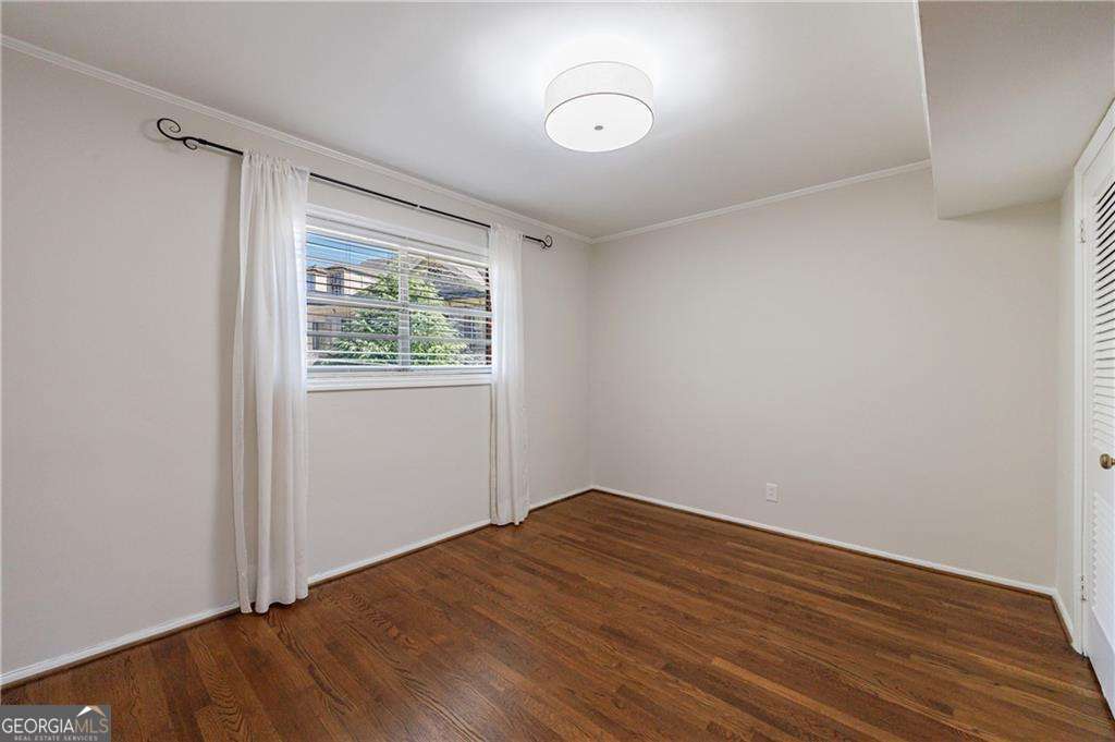 3660 Peachtree Road Northeast, Unit 2H Atlanta, GA 30319 - Photo 12 of 56 an empty room with wooden floor and windows