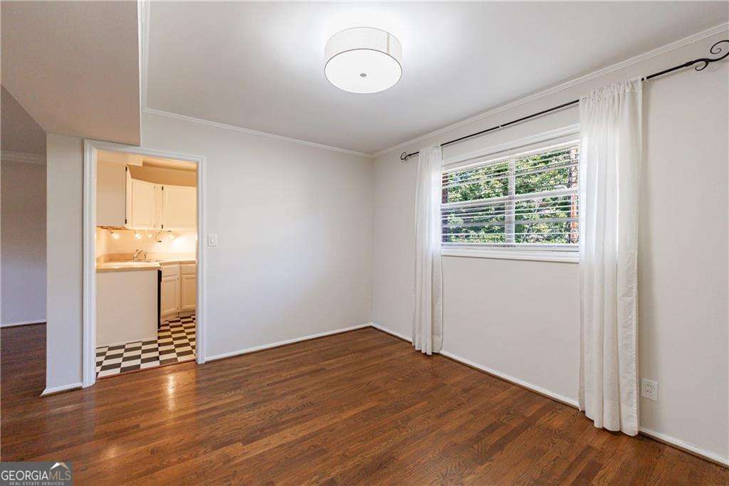3660 Peachtree Road Northeast, Unit 2H Atlanta, GA 30319 - Photo 14 of 56 an empty room with wooden floor and windows