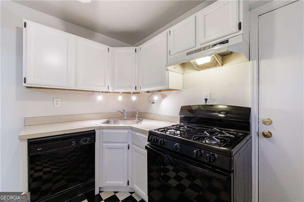 3660 Peachtree Road Northeast, Unit 2H Atlanta, GA 30319 - Photo 15 of 56 a kitchen with a stove and a cabinets