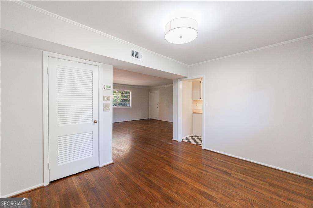 3660 Peachtree Road Northeast, Unit 2H Atlanta, GA 30319 - Photo 19 of 56 an empty room with wooden floor and windows