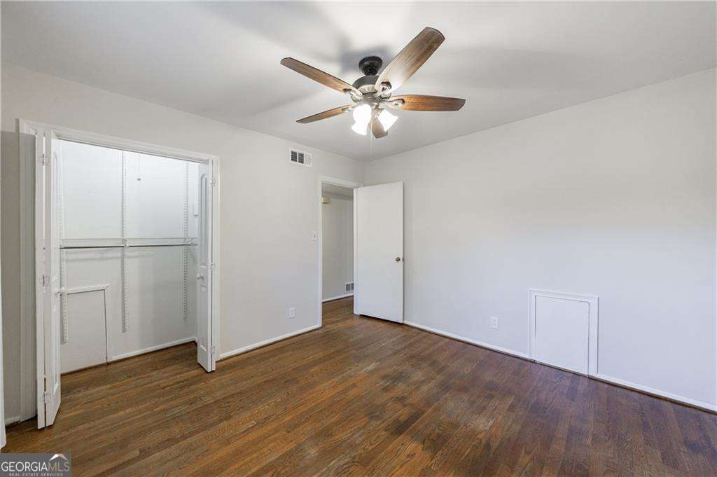 3660 Peachtree Road Northeast, Unit 2H Atlanta, GA 30319 - Photo 23 of 56 a view of an empty room with wooden floor