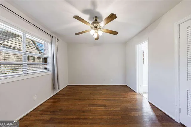 a view of an empty room with wooden floor
