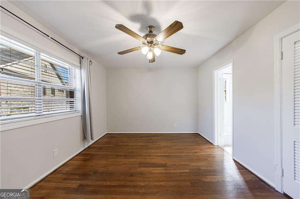 3660 Peachtree Road Northeast, Unit 2H Atlanta, GA 30319 - Photo 25 of 56 a view of an empty room with window and wooden floor