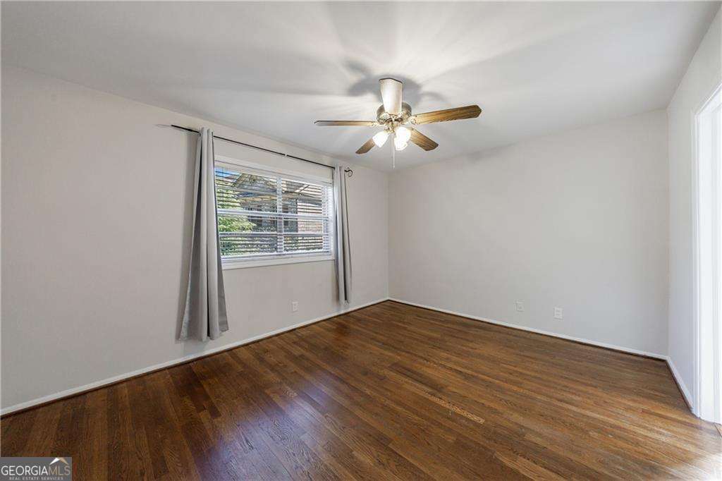 3660 Peachtree Road Northeast, Unit 2H Atlanta, GA 30319 - Photo 26 of 56 a view of empty room with wooden floor and fan