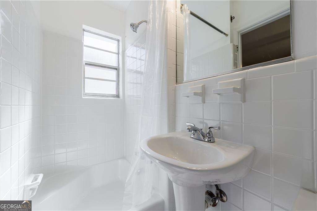 3660 Peachtree Road Northeast, Unit 2H Atlanta, GA 30319 - Photo 30 of 56 a bathroom with a sink a toilet and shower