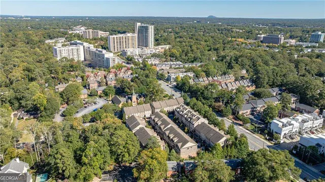 an aerial view of a residential houses with yard